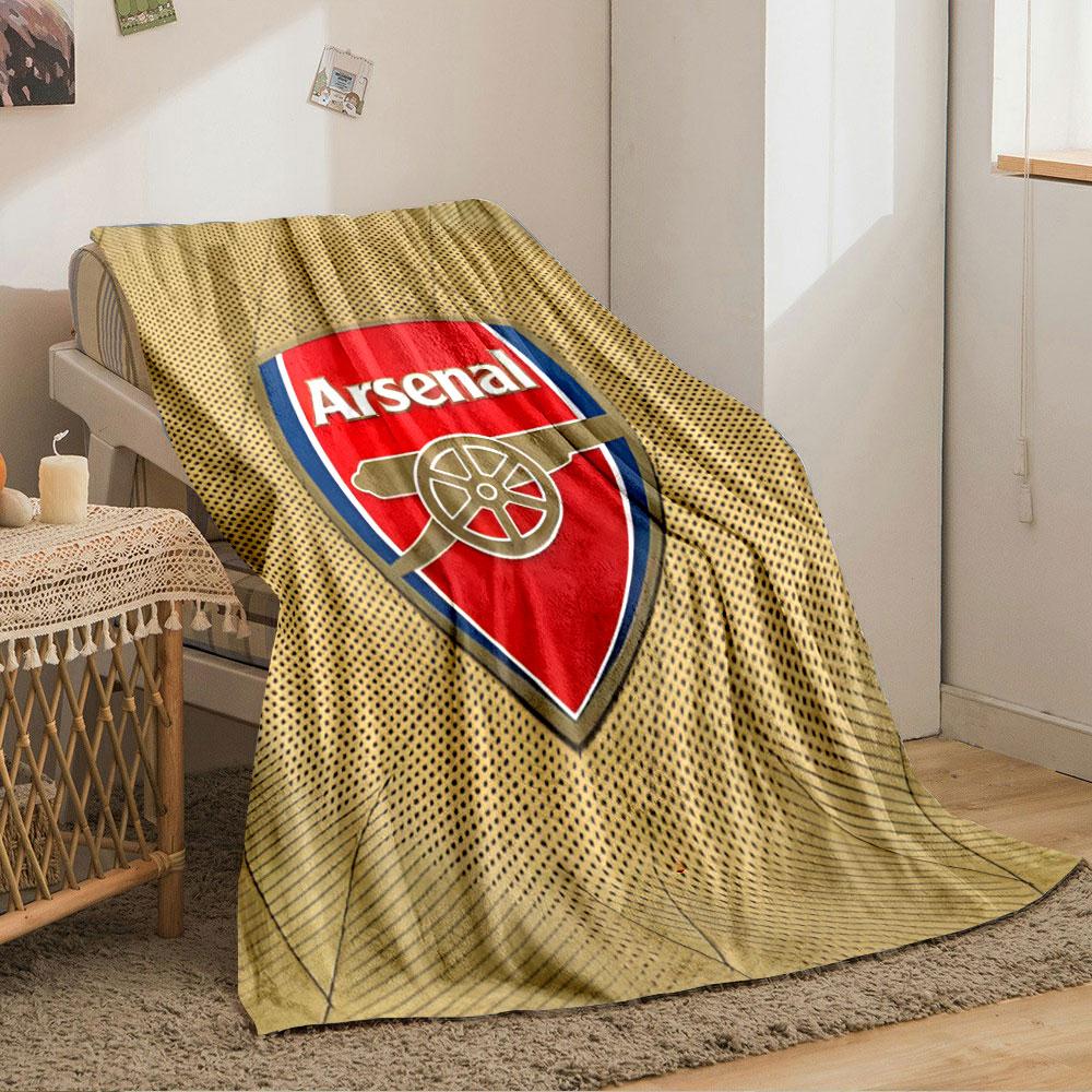 A red shield logo with a cannon design, surrounded by a gold dotted pattern. for all seasons blanket lunch break throw gift