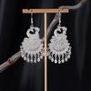 Bohemian Ethnic Miao Silver Tassel Earrings with Butterfly, Peacock, and Flower Design for Women – Long Dangle Jewelry for Travel Photos.