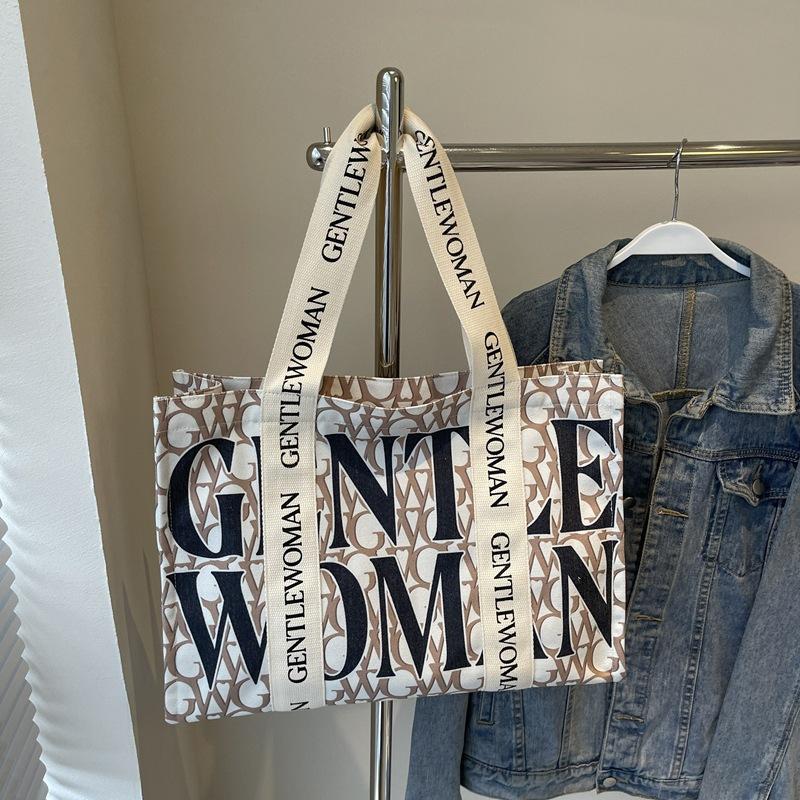 Large capacity alphabet canvas bag women's 2025 new fashion niche shoulder bag college student class commuter bag