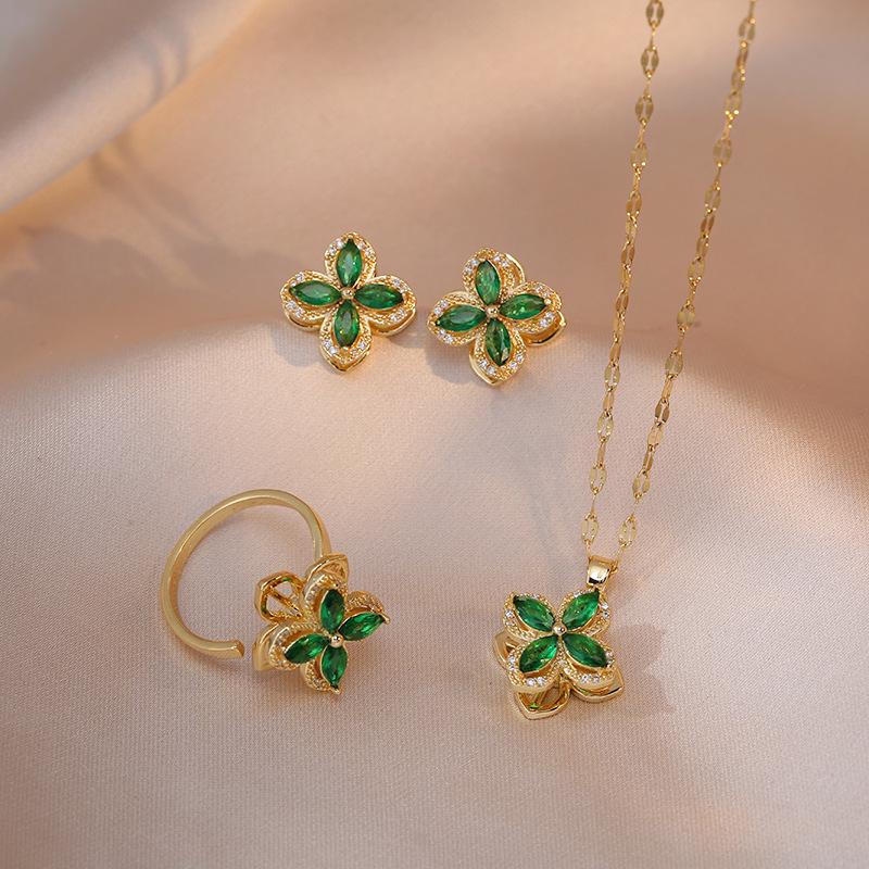 

Women s Four-Leaf Flower Jewelry Set: Japanese-Korean Style Necklace, Rotating Earrings, and Ring in Micro-Inlaid Titanium Steel.