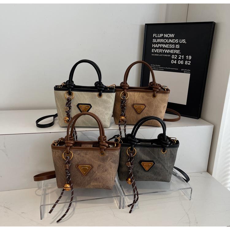 Spring new simple retro hand bucket bag women's shoulder bag high-end texture niche messenger bag