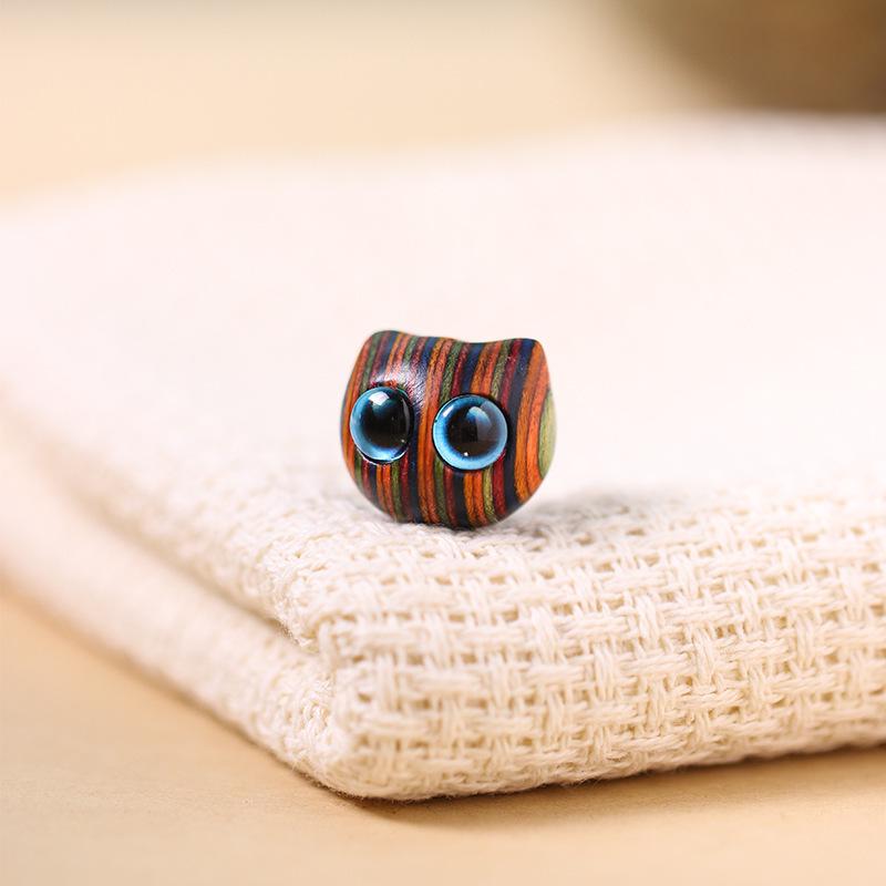 Ebony Carved Cat Pendant with Inlaid Blue and Yellow Eyes