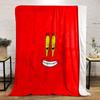 A cartoonish smiling face with big yellow eyes on a red background. for all seasons blanket lunch break throw gift