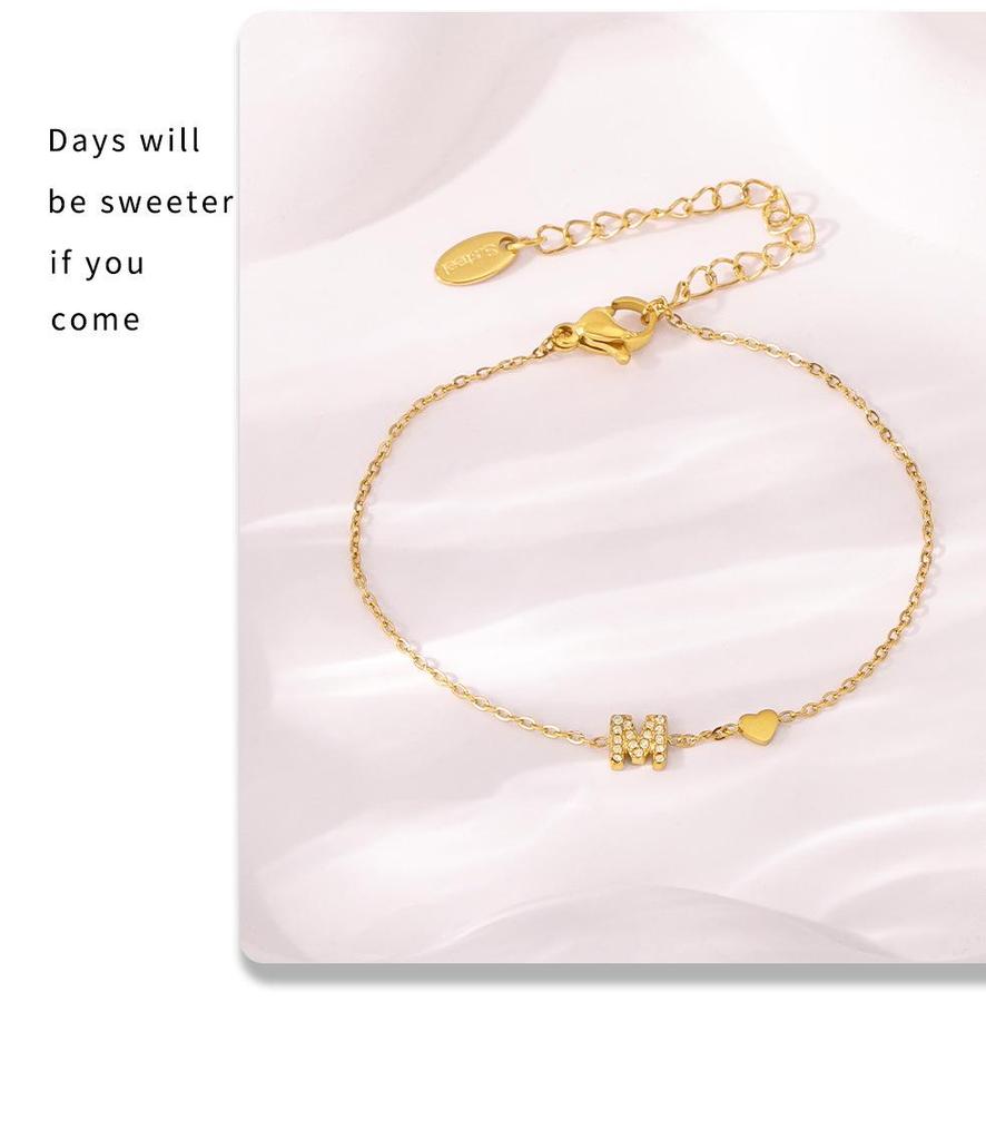Oumeika Titanium Steel Jewelry Set: 26 Zircon-Inlaid Letters, PVD Gold-Plated Necklace, Bracelet, Earrings, and Ring.