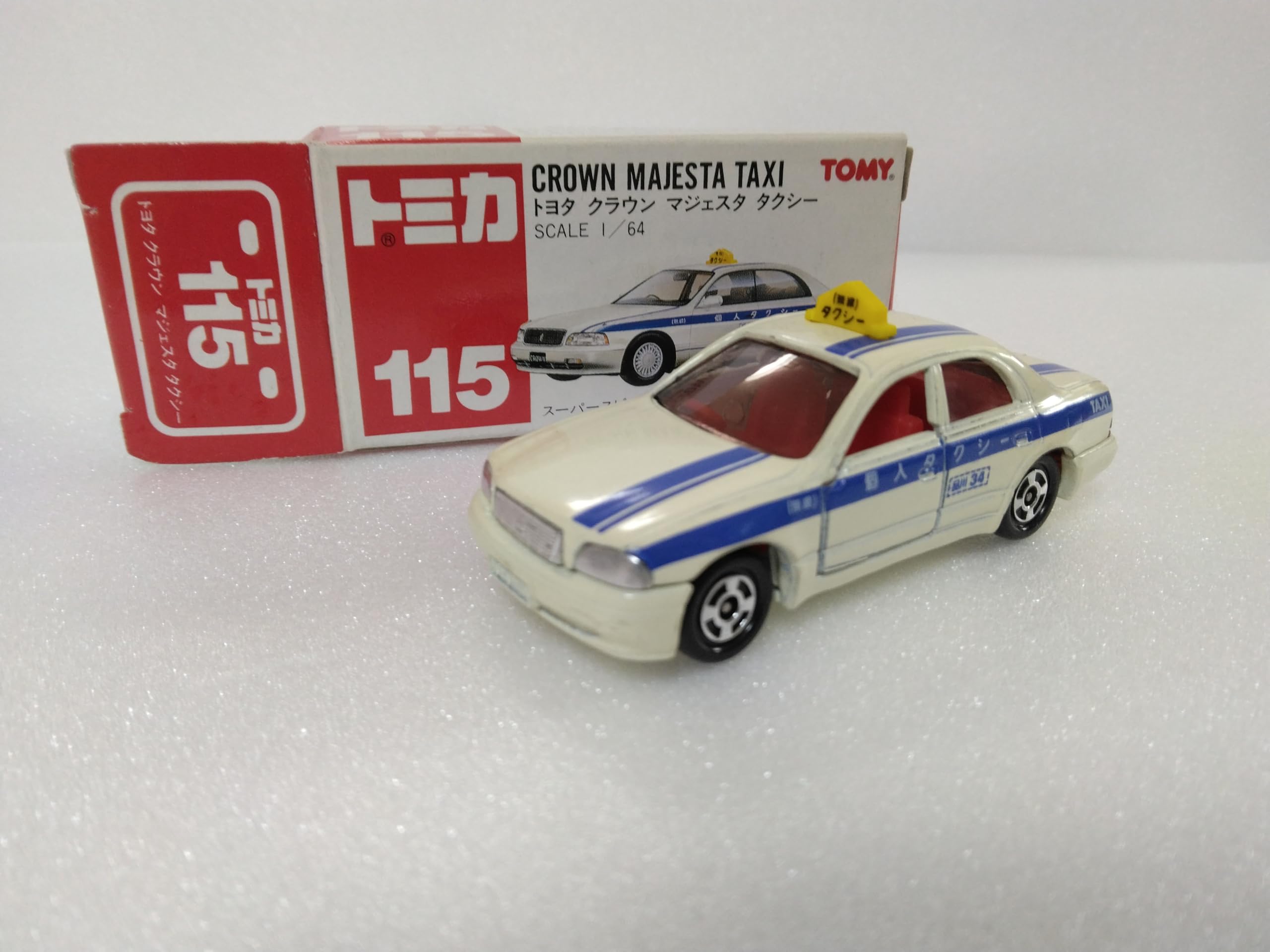 

Tomica Toyota Crown Majesta №115 Такси, масштаб 1/64, белый/синий