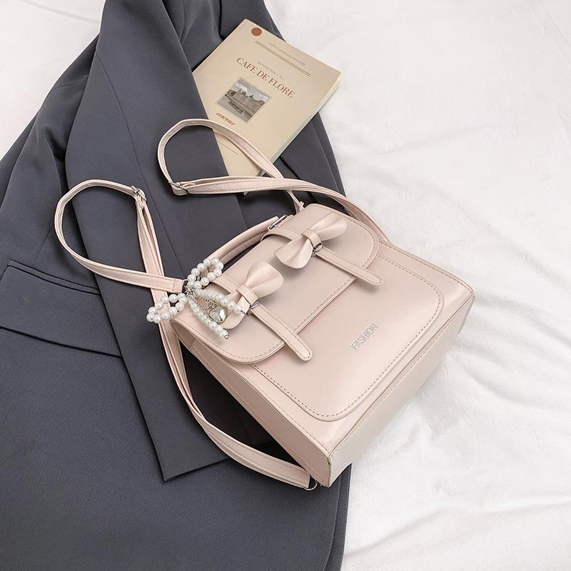 South Korea solid color college style commuter backpack women 2025 new trend bow portable shoulder messenger bag