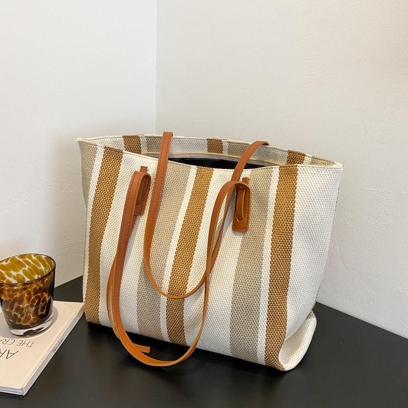 

Niche canvas bag cloth bag large capacity commuter high sense big bag women 2025 new shoulder tote bag коричневый