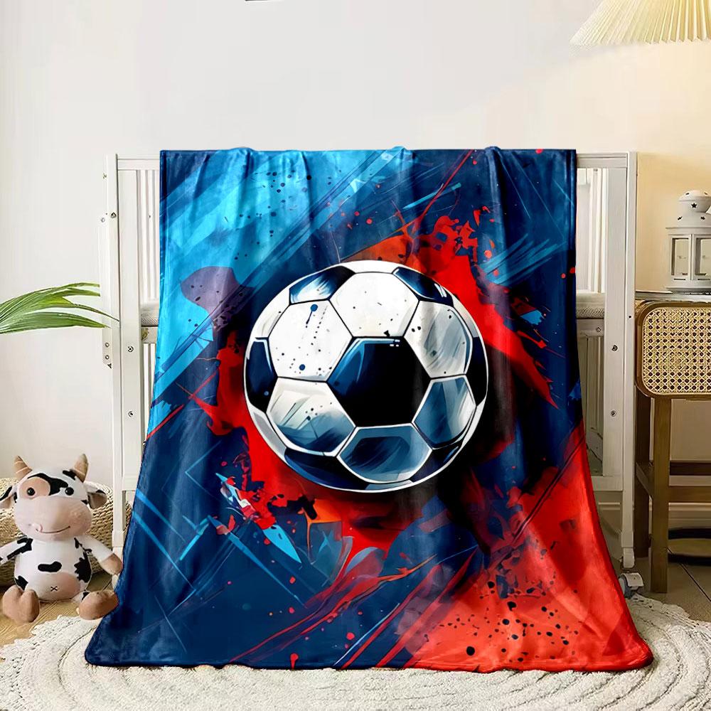 

A soccer ball with bold splashes of red and blue on a dynamic background. for all seasons blanket lunch break throw gift 80cm x 120cm
