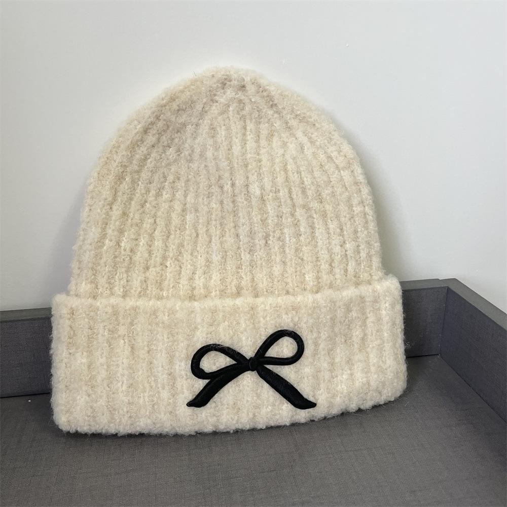 Hat women's autumn and winter wool hat new cute bow versatile cold hat ear protection warm knitted hat tide
