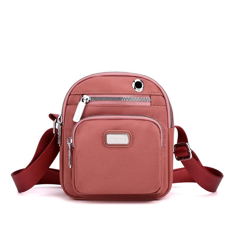 

New women s oblique span small square bag, solid color nylon bag, casual with earphone hole, mobile phone key change bag. рожевий