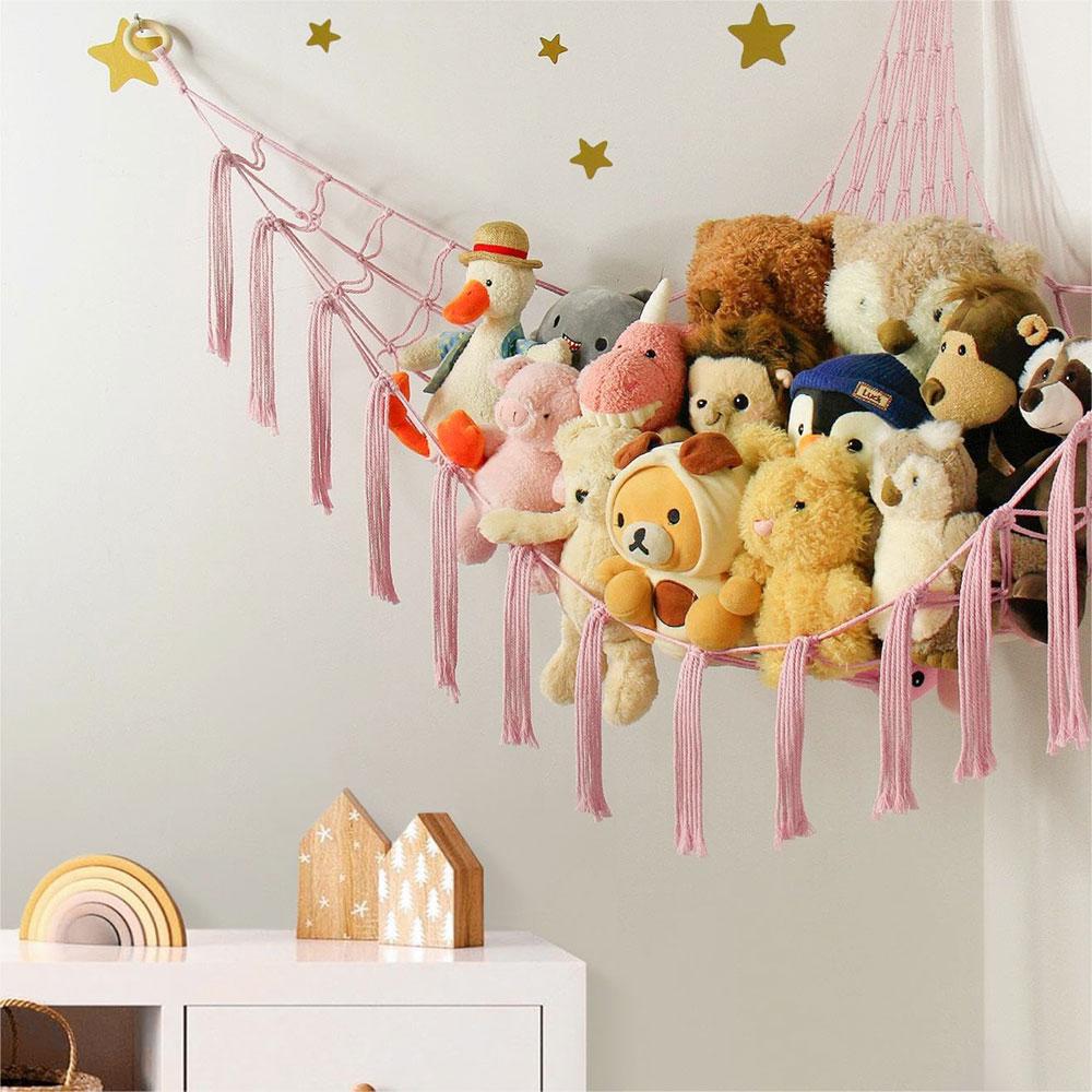 Toy hammock is hung in the corner and is equipped with a storage net, a toy storage bag, and a wall-mounted hammock.