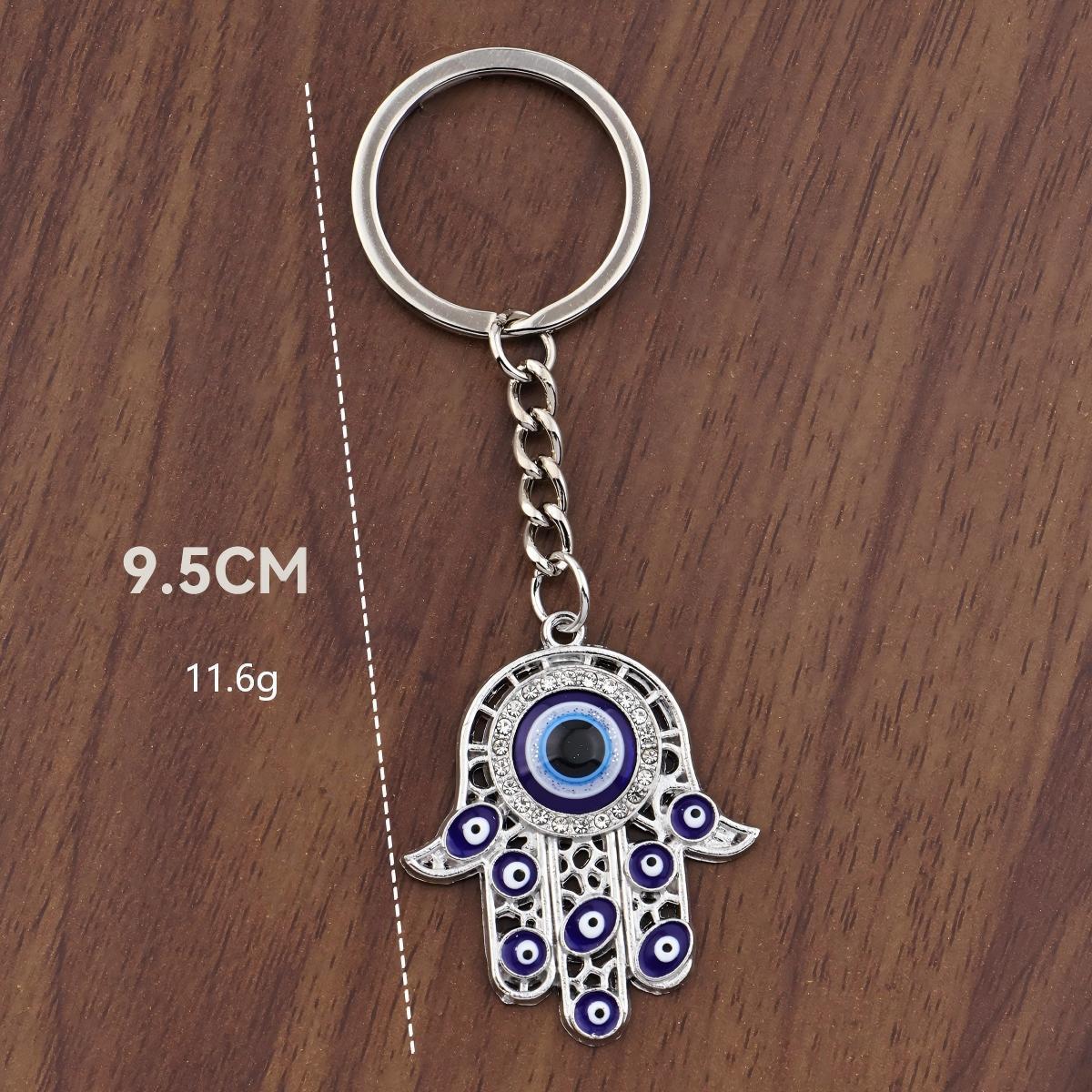 

Devil s Eye Keychain with Hamsa Hand & Blue Rhinestone - Stylish Bag Ornament