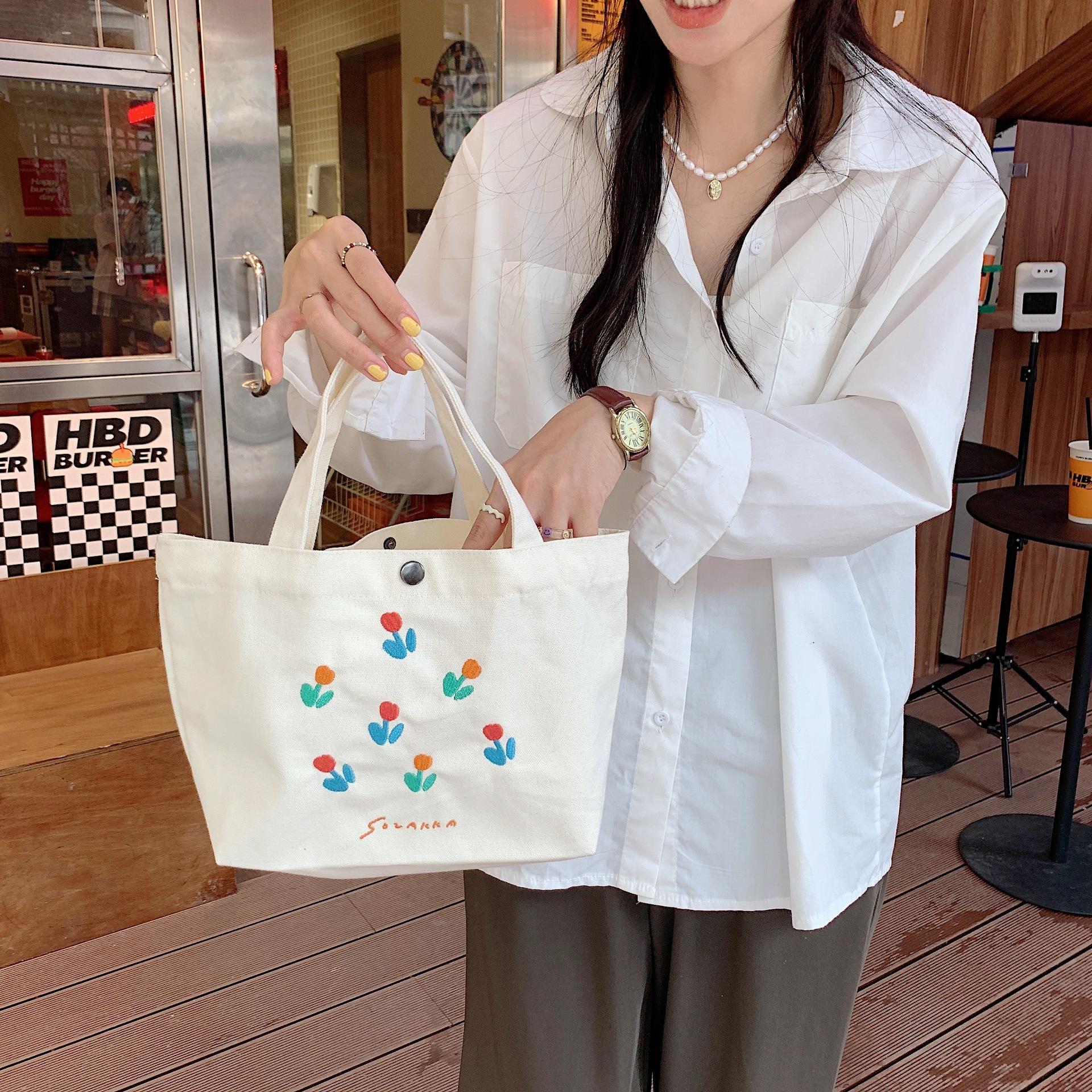 

Портативна проста маленька свіжа портативна сумка тюльпана відповідного кольору студентського класу. Портативна сумка помаранчевий