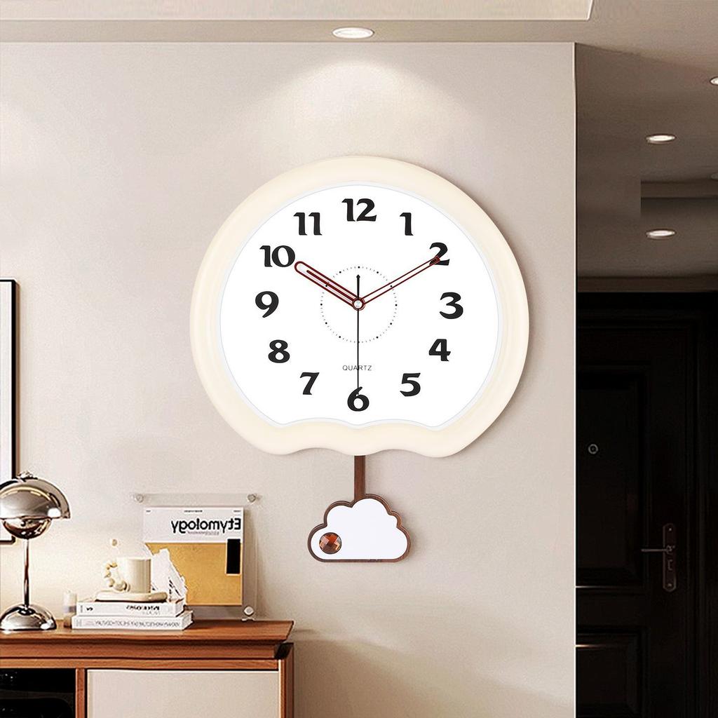 This wall clock is a modern, creative and personalized quartz clock for home use in the living room with a simple cream style