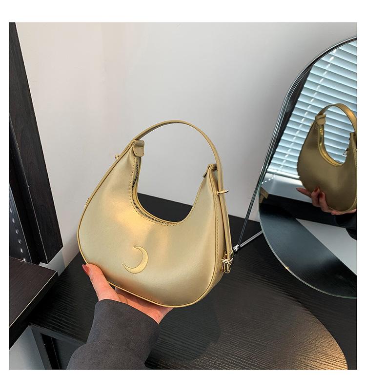 

Жіноча жіноча сумка з суцільним кольоровим дизайном у 2024 році, нова модна проста персоналізована сумка у вигляді півмісяця під пахвами Персоналізована портативна сумка через плече золотий