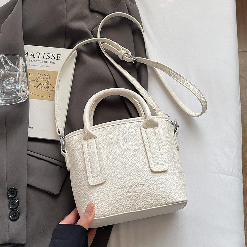 Spring and summer popular solid color simple high quality lychee pattern portable bucket bag women's fashion versatile commuter messenger bag