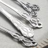 40pcs Elegant Silver Cutlery Set Features Stainless Steel Openwork Handles and Includes Forks, Spoons, and Knives. Perfect for W