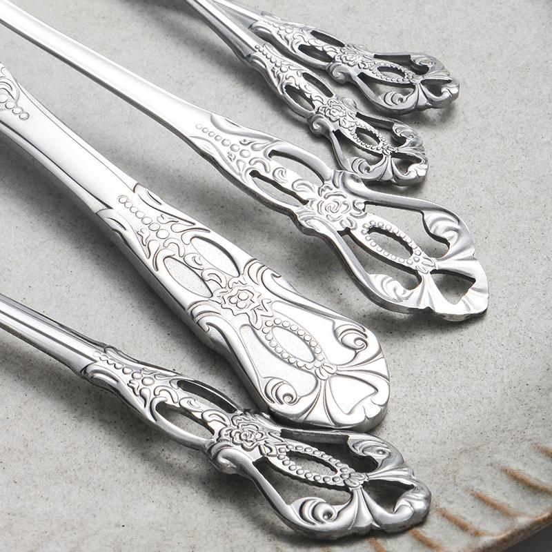 40pcs Elegant Silver Cutlery Set Features Stainless Steel Openwork Handles and Includes Forks, Spoons, and Knives. Perfect for W