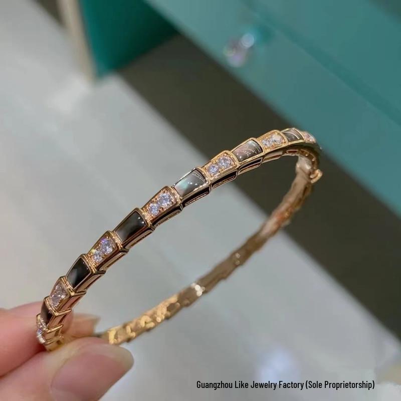 

Women s Sterling Silver Snake Bone Bracelet with Diamond, Mother-of-Pearl, Red Agate, and Rose Gold Snake Design.