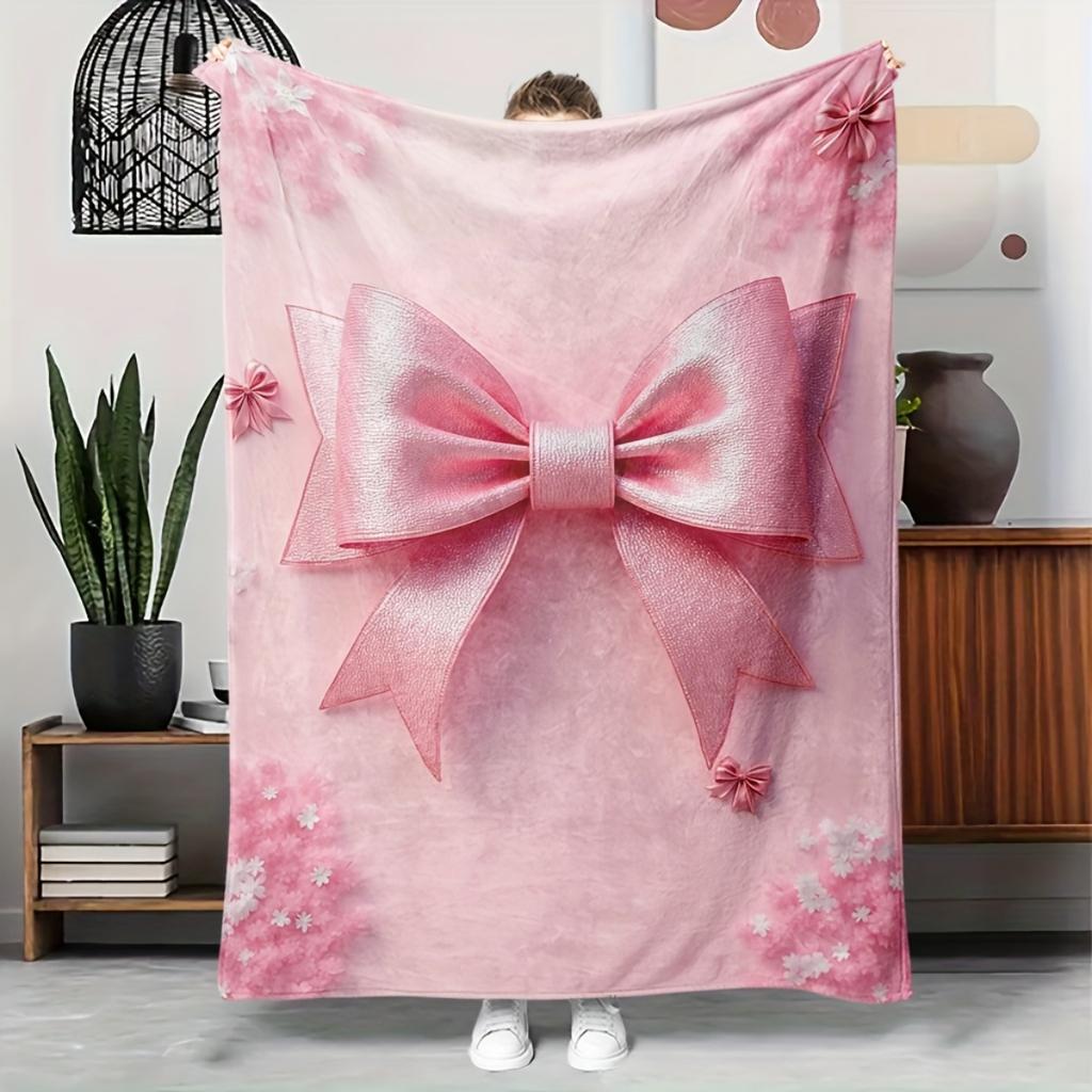 A Cozy Pink Flannel Blanket with a Bow Pattern - Soft and Warm, Perfect for Camping, Lounging On the Sofa, Bed, or Chair; a Grea