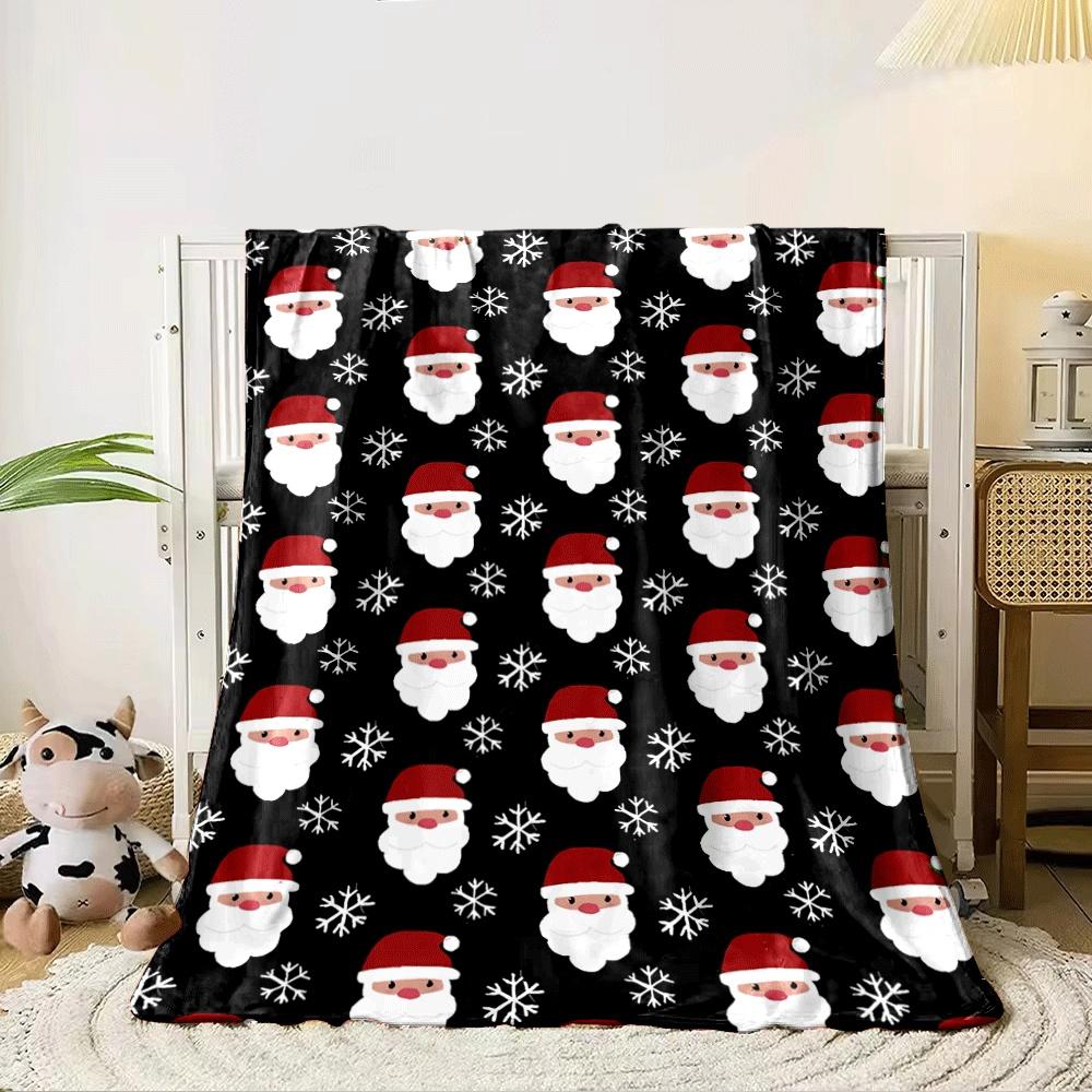 Santa faces and snowflakes arranged in a repeating pattern on a black background. for all seasons blanket lunch break throw gift 80cm x 120cm