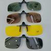 A pair of stylish four-piece flip-on polarized night vision sunglasses with an anti-glare mirror coating, ideal for driving.