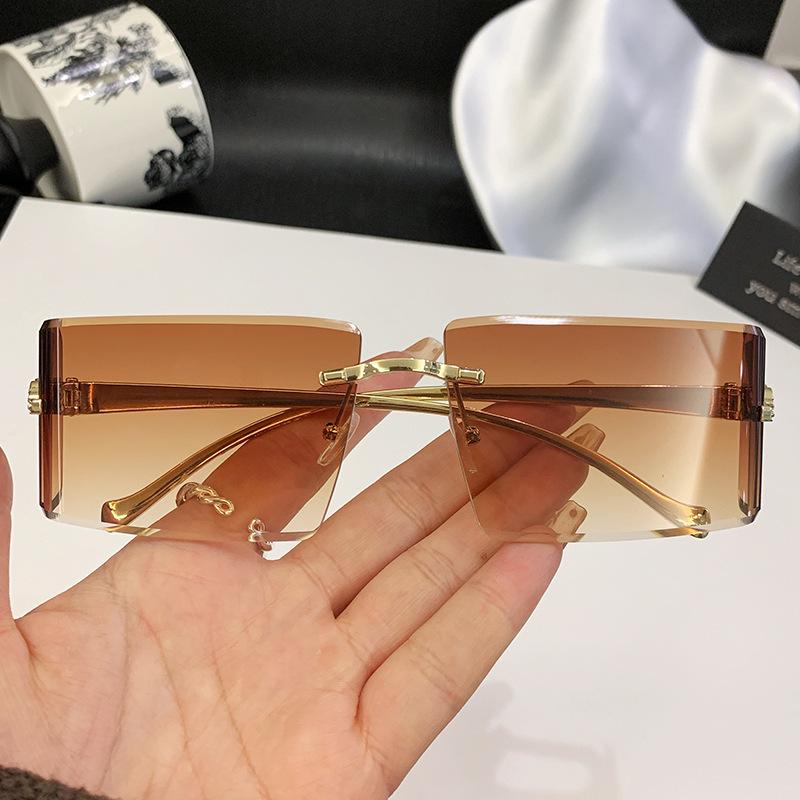 New European and American curved lenses leopard head metal frameless trimmed high-end sunglasses European and American sunscreen glasses