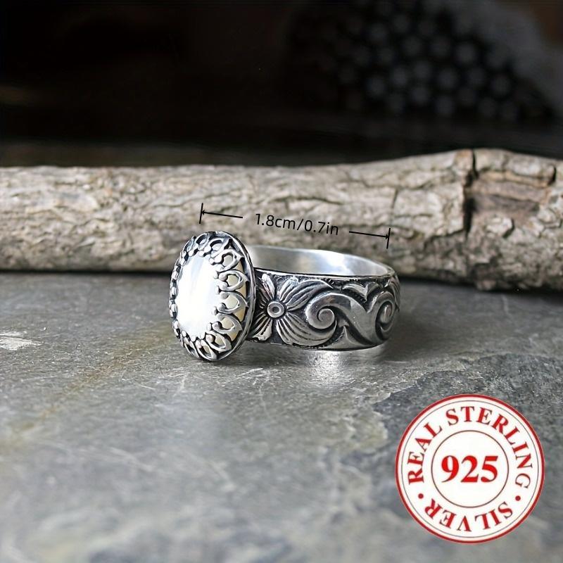 Vintage-style 925 sterling silver ring with oval moonstone and floral motif design, suitable for engagement