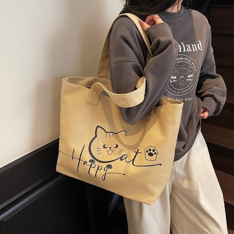 2025 Herbst neue Canvas-Tasche tragbar Schulter große Kapazität Cartoon niedlich Mode einfach Nische Tragetasche