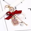 Korean-Style Handmade Rhinestone Perfume Bottle Keychain with Bow and Pearl Charm