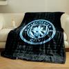 A glowing neon emblem with a ship, rose, and "Manchester City" text. for all seasons blanket lunch break throw gift