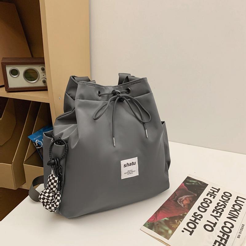 New dual-purpose small backpack, casual niche girlfriend handheld shoulder bag, Japanese and Korean drawstring commuter work backpack