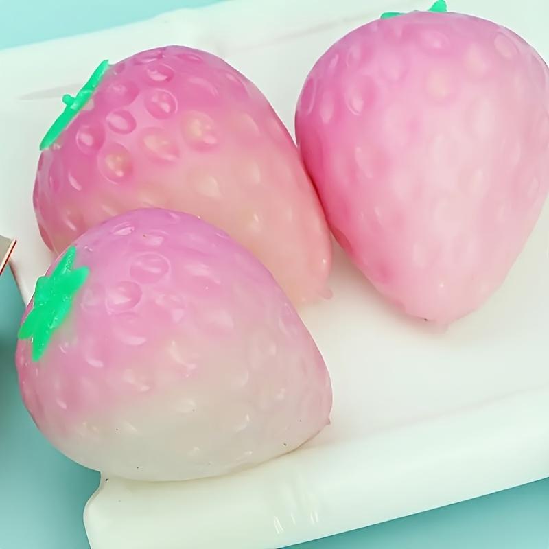 1 Simulated Color Changing Strawberry Toy, A Stress Relief Toy That Changes Color In The Sunlight, and A Decompression Rebound
