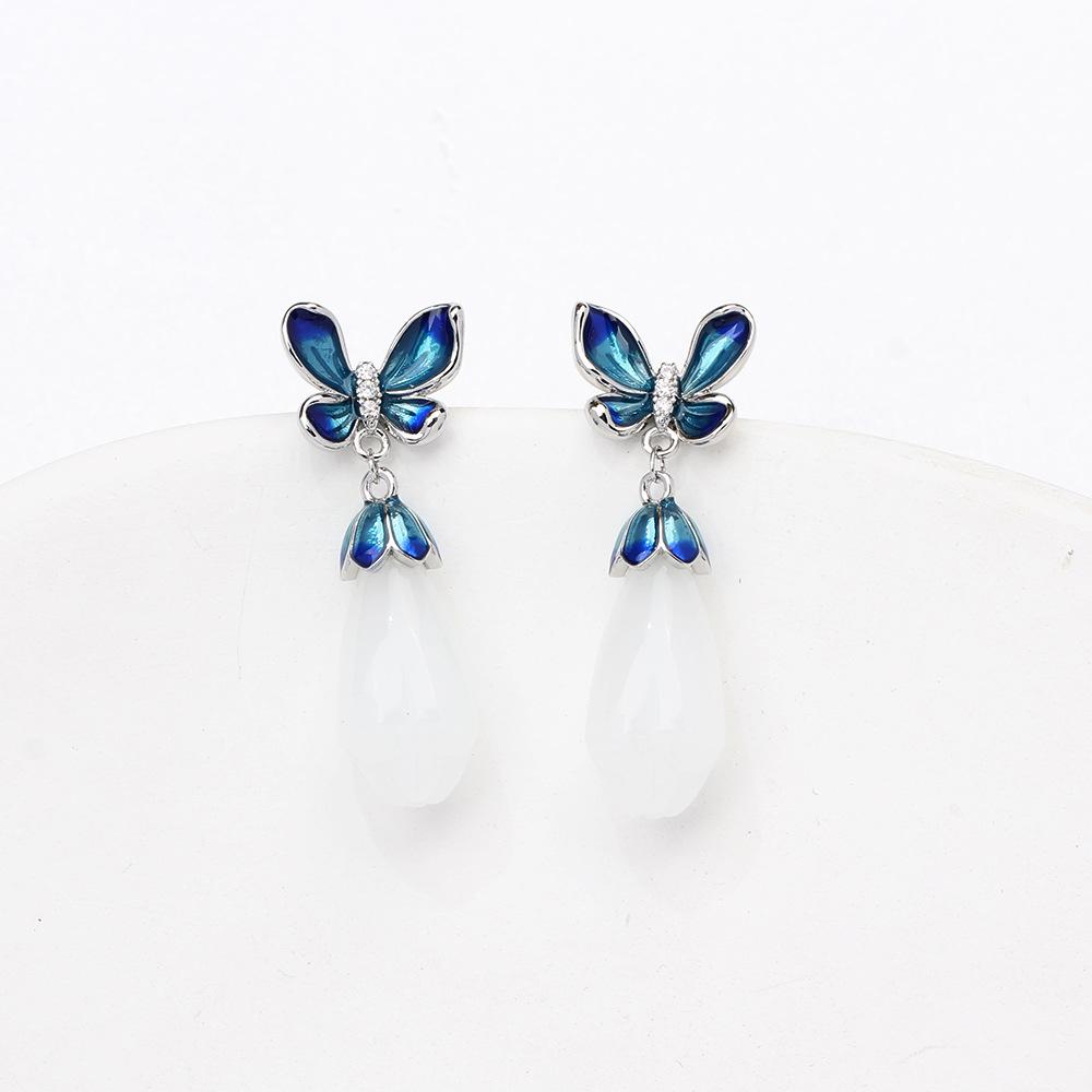 Elegant and elegant blue dripping butterfly stud earrings with simple temperament white magnolia flower imitation jade earrings silver needle women's