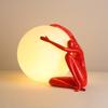 Modern Nordic Table Lamp Sculpture: Creative Doll Holding Luminous Ball for Bedroom and Living Room Decor