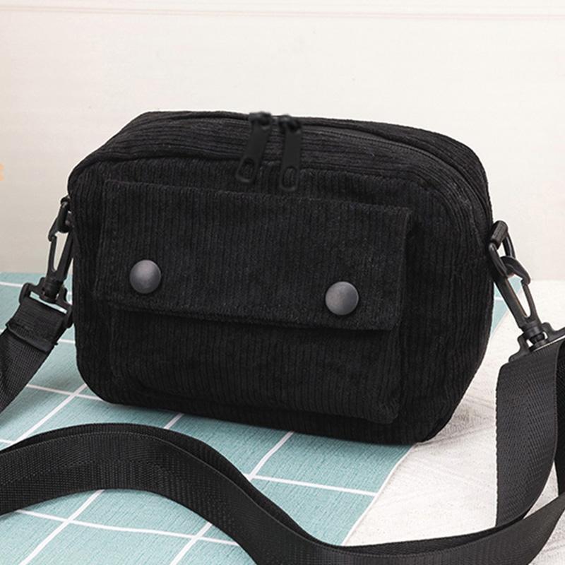 Neutral men's and women's cross-body bag with shoulder strap, made of corduroy material, with a flap design  the outside.