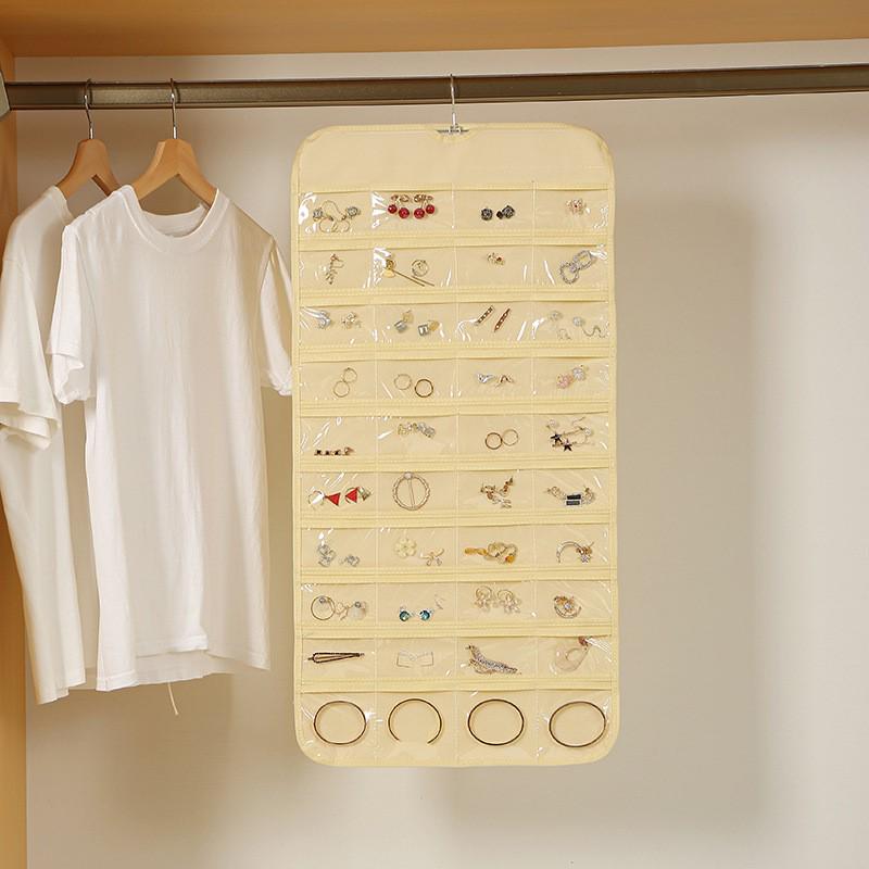 Double-Sided Non-Woven Jewelry Organizer: 80-Compartment Hanging Bag for Earrings and Small Items, Dustproof Storage Solution.