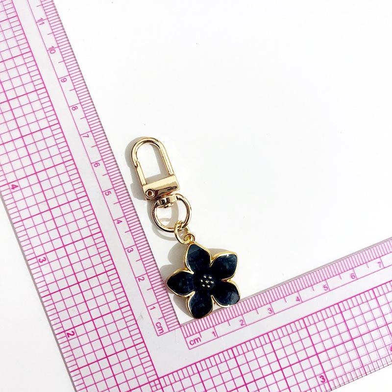 

Pearlescent Cherry Blossom Keychain: Enamel Flower USB Drive & AirPods Pendant