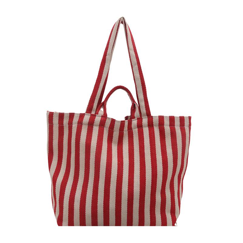 

Canvas bag women s large capacity 2025 new autumn and winter versatile striped shoulder shopping bag class commuter tote bag червоний