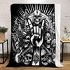A skull-heavy design with a "rock on" hand gesture, guitars, and dark motifs. for all seasons blanket lunch break throw gift