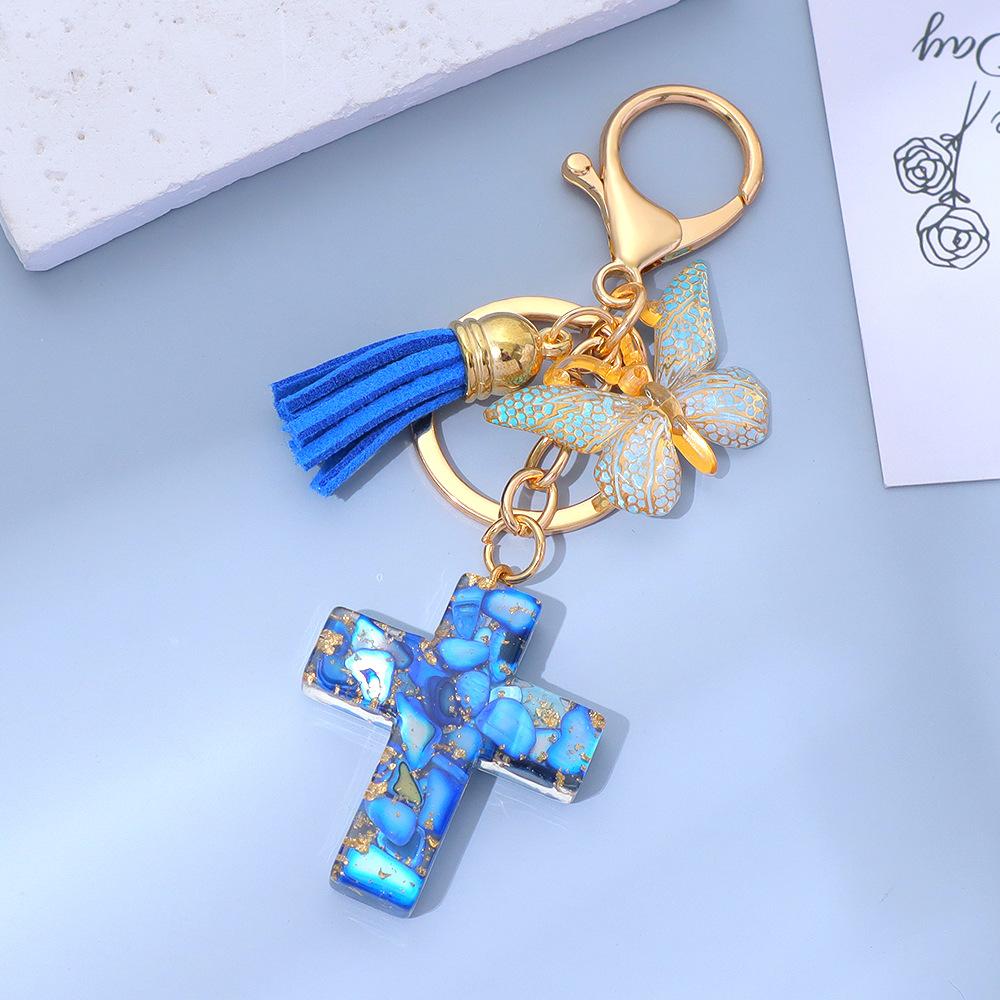 Ключница-крестик из смолы с подвеской-бабочкой и кисточкой One Size синий