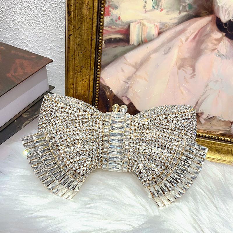 

Vintage shiny, diamond-encrusted, diamond-filled dinner bag, court-style metal bow, messenger bag in hand.