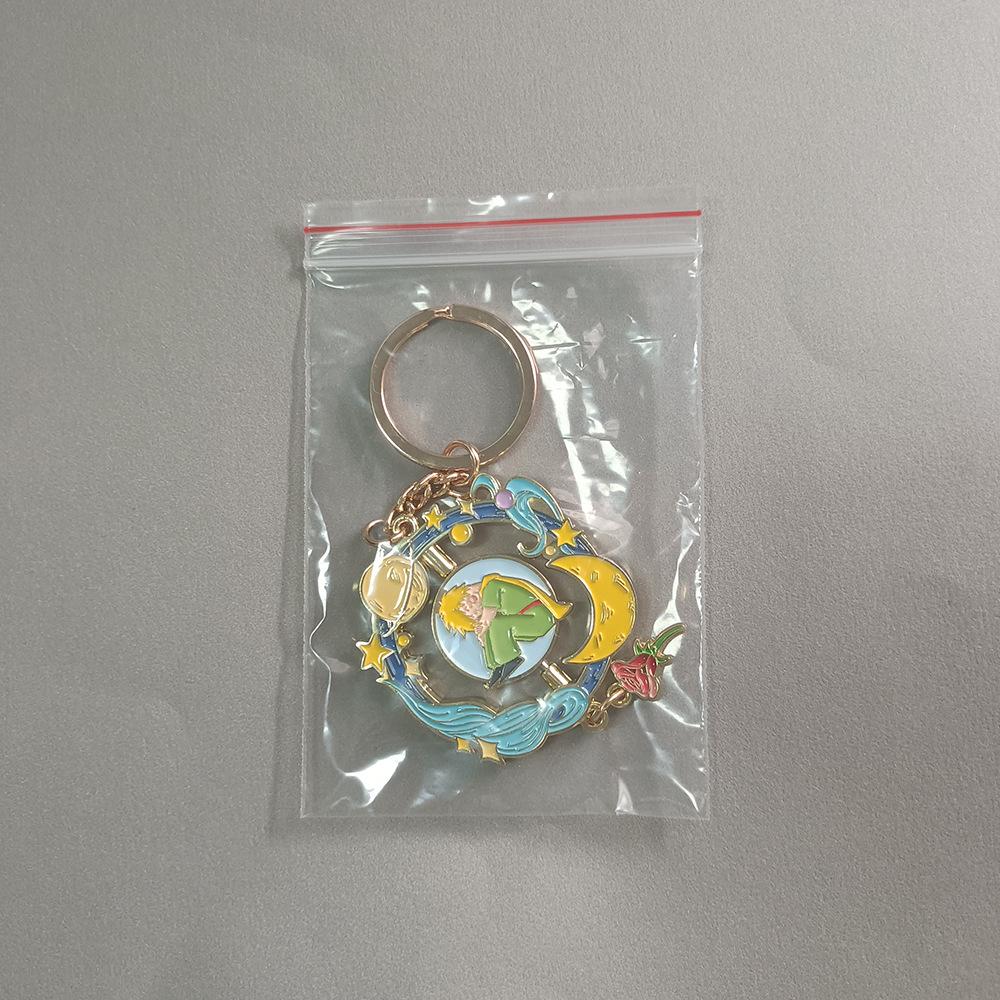 Breloc Planetă Micul Prinț cu Pandantiv Trandafir – Accesoriu de Modă Metalic Rotativ Creativ