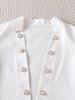 Women's Autumn Fashion Set: White Jacket with Pearl Buttons & Color Block Jumpsuit with Metal Chain Trim.