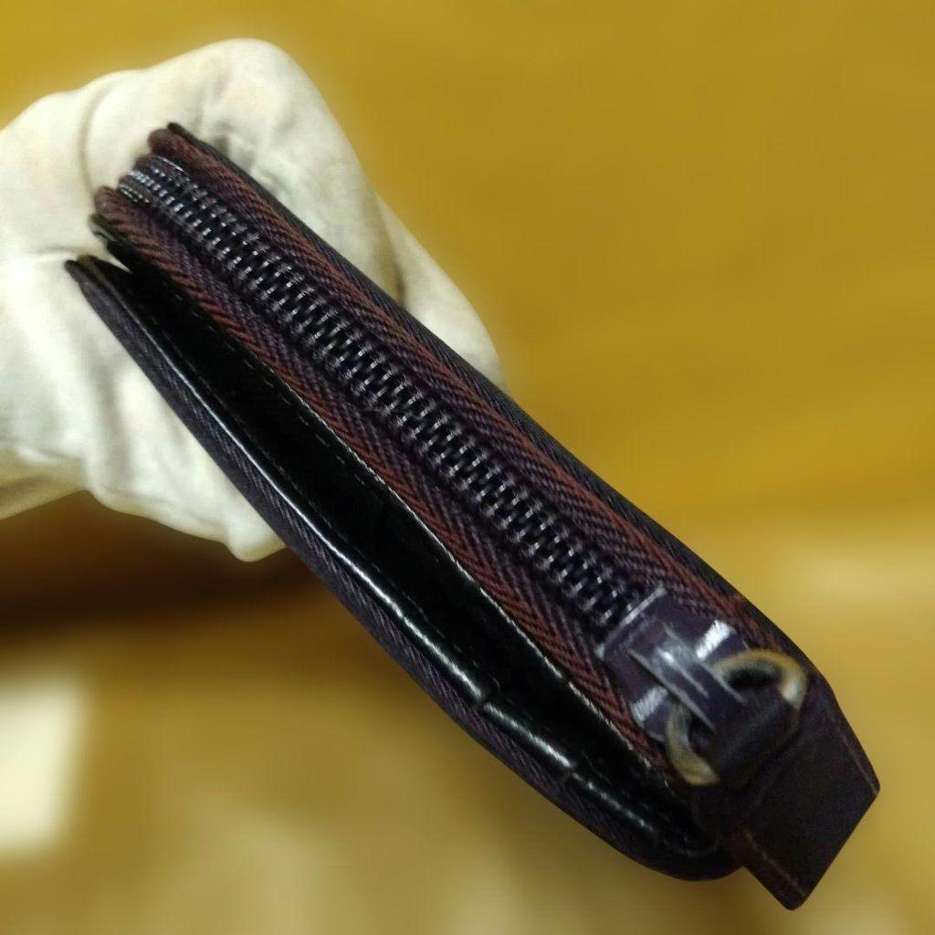 Used Excellent condition PRADA dry plum color bi-fold wallet with triangle logo plate and zipper