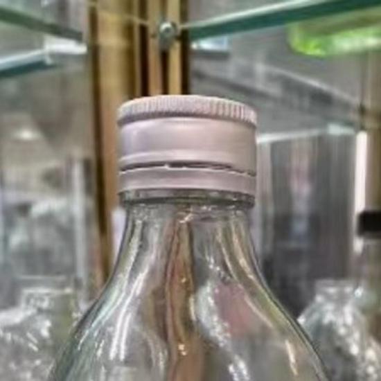 Transparent Round Glass Bottles with Lids for Juice, Milk, Tea, Cold Brew, and Coffee.