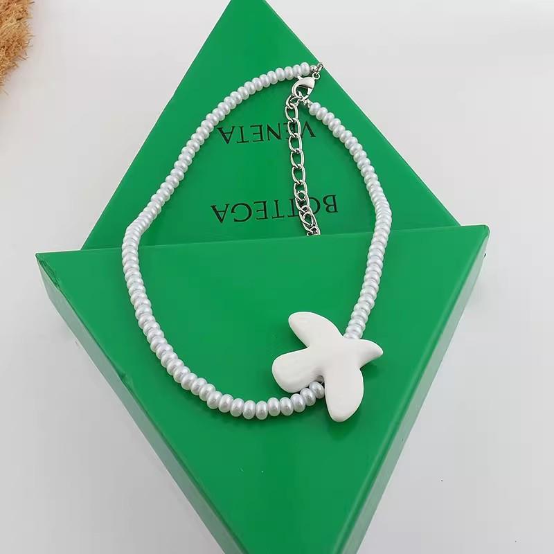 

White ceramic peace dove necklace tied black rope long sweater chain can be used as waist chain fashion jewelry accessories Other