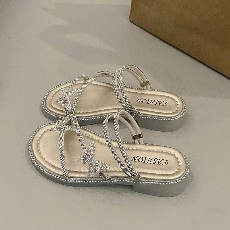Beautiful slippers female 2025 summer wear new Internet celebrity butterfly rhinestone one-word drag fairy wind beach two sandals