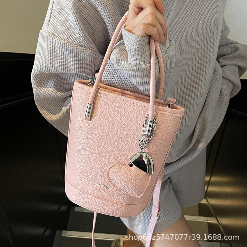 New niche simple solid color lychee pattern texture hand carrying bucket bag versatile foreign style commuting messenger women's bag
