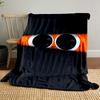 Large eyes with a sad expression peek through black horizontal slits. for all seasons blanket lunch break throw gift